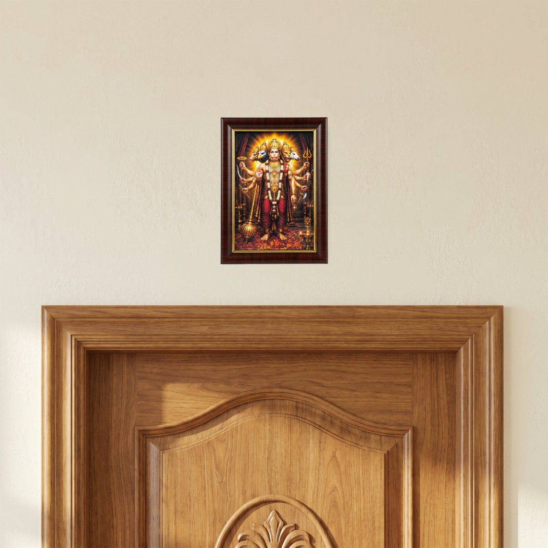 The Panchmukhi Hanuman Ji photo frame mounted on a light beige wall directly above a premium wooden doorway for Vastu protection and positive energy.