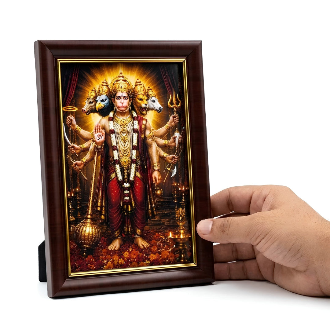 A person's hand holding the compact 4x6 inch Panchmukhi Hanuman photo frame to demonstrate its perfect size for desks, dashboards, or small shrines.